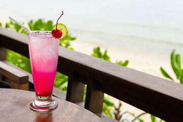 Cocktail on the table and sea in background.