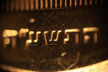 Texture of the engraved words on the jewish coin in macro	
