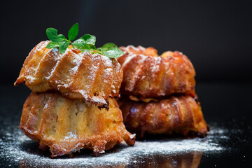 cooked sweet honey muffins in powdered sugar