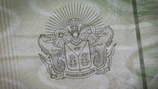 Checking the document for authenticity. Coat of arms of the Kingdom of North Barchant on paper with watermarks and metal protection. Passport of a virtual state and protection against counterfeiting.