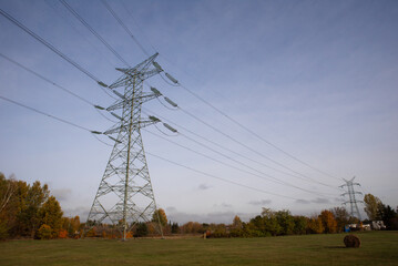 High voltage post through a rural landscape