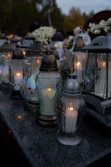 Burning vigil lights in the cemetery - obrazy, fototapety, plakaty