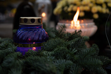 Burning purple vigil light in the cemetery - obrazy, fototapety, plakaty