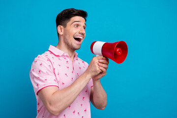 Profile photo of impressed positive person hold loudspeaker toa communicate empty space isolated on blue color background