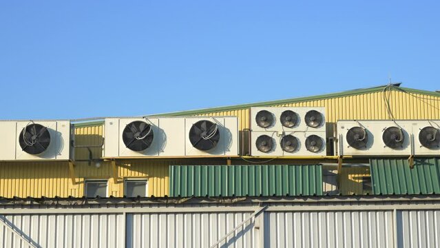 Heat pump and air conditioner external units on top of industrial building