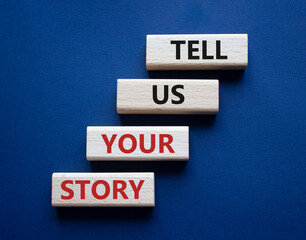 Tell us your story symbol. Concept words Tell us your story on wooden blocks. Beautiful deep blue background. Business and Tell us your story concept. Copy space.