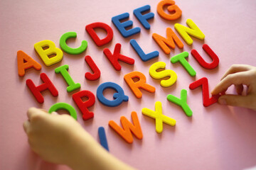 english alphabet. kid playing alphabet letters. Intellectual game, preschool primary education,...