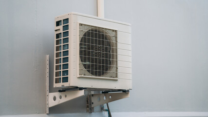 Air conditioner compressor installed on the wall of a building. Cooling systems of  Industrial air conditioning and ventilation systems.