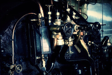 The comnmands, gears and indicators of a real vintage steam train, evoking the intricate allure of...