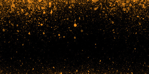 Abstract shiny golden glitter is falling randomly on black background perfect for design, presentation, holiday, weeding card and decoration related works.