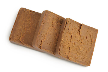 Brown cheese. Norwegian brunost isolated on white background. Top view. Flat lay