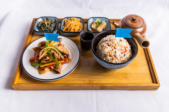 XO pork with boiled rice dish isolated on wooden board side view of japanese food on table