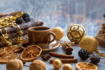 Christmas mood, holiday atmosphere. Coffee mug, Christmas decor, plaid, cones, cinnamon, star...