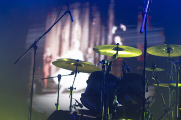 A drum set under spotlight on stage.