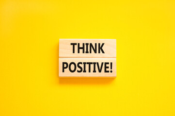Think positive symbol. Concept words Think positive on beautiful wooden block. Beautiful yellow...