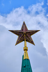 Ruby star on peak Spasskaya tower against sky.