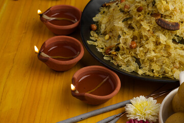 Poha Chivda or Chiwada. Diwali special savory snack, made out of Flattened rice, fried peanuts, curry leaves and some spices. Traditional Indian Diwali Snacks.