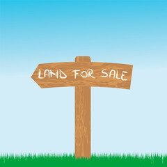 Land for sale wooden sign in a green area
