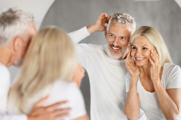 Beauty Care Concept. Happy Senior Couple Making Morning Routine In Bathroom