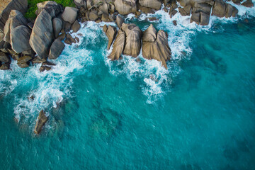 Bird eye drone shot of north east point beach, granite rocks, turquoise water, waves crashing, greenery, Mahe Seychelles 4 - obrazy, fototapety, plakaty