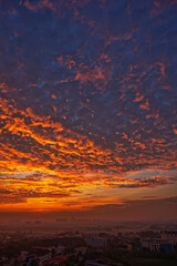 Sunrise over the city with red clouds