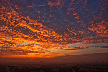 Sunrise over the city with red clouds