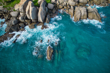 Bird eye drone shot of north east point beach, granite rocks, turquoise water, waves crashing, grenery, Mahe Seychelles 9 - obrazy, fototapety, plakaty