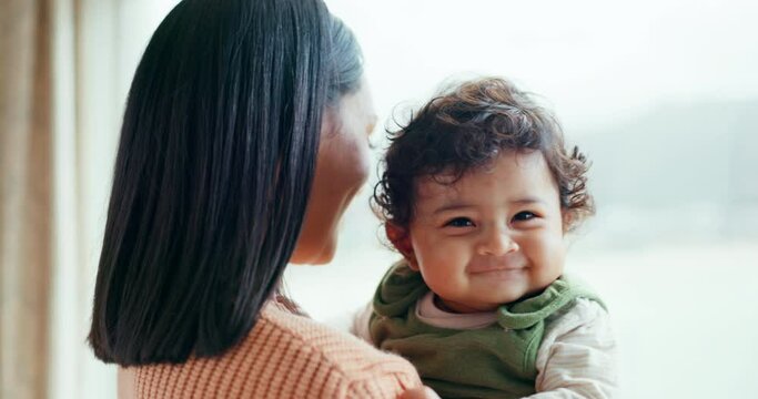 Mother, newborn and smile by window, home and happy together with care, love and bonding in childhood. Mom, infant baby and excited with connection, development and hug at family house in Canada