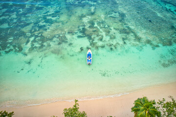 Drone of baie lazare beach, docking fisherman boat on low tide near the shore, turquoise water, sunny day, Mahe Seychelles 2.