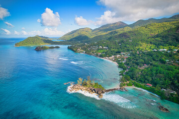 Drone shot from port glaud beach, Lilette island and the port launay and port glaud distict area, turqouise water and calm sea, Mahe Seychelles