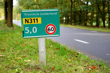 Street name sign at the provincial road N311 'Koningsweg' near Dutch city of Arnhem, with maximum...
