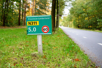 Street name sign at the provincial road N311 'Koningsweg' near Dutch city of Arnhem, with maximum speed in kilometer written