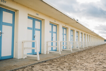 a symmetrical line of beach cabins