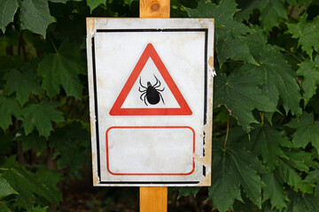 A warning sign about ticks, indicating the danger of tick bites and the risk of Lyme disease. Ideal...