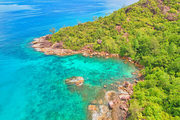 Fototapeta premium Drone shot of Anse Major beach, transparent sea, lush forest and granite stones, Mahe, Seychelles 6