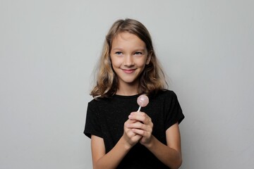 Girl child with candy on stick smiling