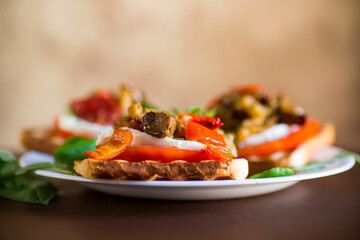 Prepared sandwich with tomatoes, mozzarella and fried eggplant with mushrooms.