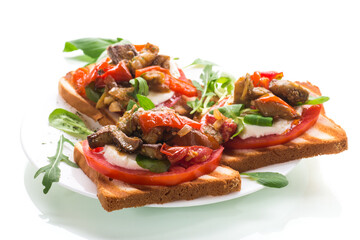 Prepared sandwich with tomatoes, mozzarella and fried eggplant with mushrooms.