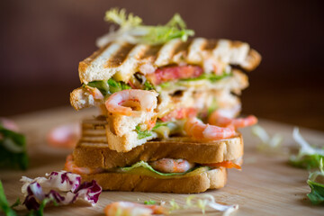 sandwich with lettuce and shrimp.