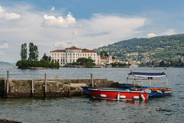 Pier in the island Isola dei Pescatori with the Isola Bella in the background, in the lake Maggiore