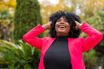 Happy african american businesswoman laughing in a park