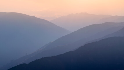 Beautiful layered blue mountains, transitioning into the sunset horizontal