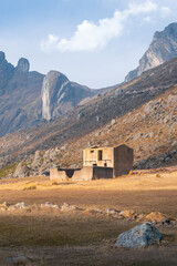 An abandoned and semi-destroyed house in the middle of nowhere in a vast Andean landscape above 3000 m above sea level vertical - obrazy, fototapety, plakaty