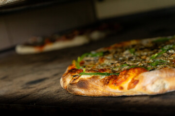 Delicious pizzas baking in a pizzeria oven, a mouthwatering sight of bubbling cheese and golden...