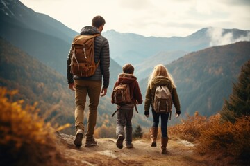 Happy family father and two children take a walk in the mountains with backpacks, hiking