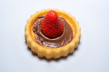 Small cake with a strawberry and chocolate cream