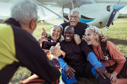 Group of senior friends celebrating their skydiving adventure together