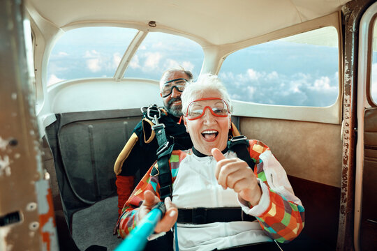 Senior couple takes a selfie aboard a plane before skydiving