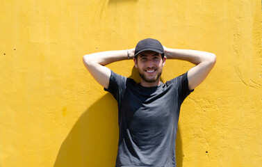 Traveler posing in front of real Hoi An yellow wall. Concept of tourism, travel and holidays.