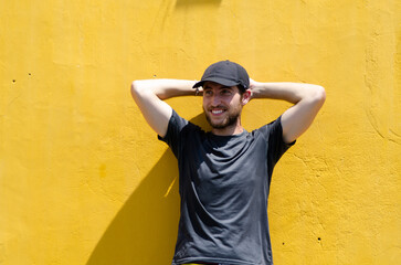 Traveler posing in front of real Hoi An yellow wall. Concept of tourism, travel and holidays.